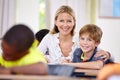Teacher woman, classroom and help boy at desk in portrait with support, advice or knowledge for education. People Royalty Free Stock Photo