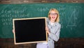 Teacher woman hold blackboard blank advertisement copy space. School information for incoming students. Teacher show