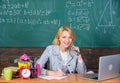 Teacher woman sit table chalkboard background. Excellent communicability and interpersonal skills. Organize class and Royalty Free Stock Photo