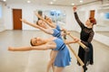 Teacher works with ballerinas at barre in class Royalty Free Stock Photo