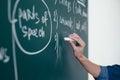 The teacher writes English rules on the blackboard. Royalty Free Stock Photo