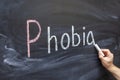 The teacher writes the word PHOBIA on a chalkboard Royalty Free Stock Photo