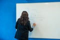 Teacher writing mathematical function on whiteboard in classroom Royalty Free Stock Photo