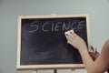 A teacher writing science, drawing chemistry elements on dark ch Royalty Free Stock Photo