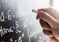 Teacher writing to blackboard with chalk. Student and chalkboard Royalty Free Stock Photo