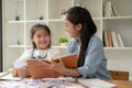 A teacher and a young girl are laughing and enjoying the English class together Royalty Free Stock Photo