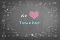 Teachers day concept with we love teacher greeting on black chalkboard with doodle