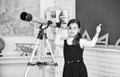 teachers day. Little girl using telescope. Telescope on tripod. School subjects set. School astronomy lesson. Exploring Royalty Free Stock Photo