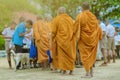 Teachers and students together make merit to give food offerings to a Buddhist monk on important religious days