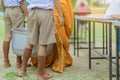 Teachers and students together make merit to give food offerings to a Buddhist monk on important religious days