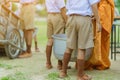 Teachers and students together make merit to give food offerings to a Buddhist monk on important religious days