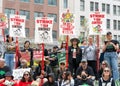 Teachers and supporters holding signs protesting at a Teacher Strike Rally in Oakland, CA