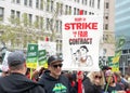 Teachers and supporters holding signs protesting at a Teacher Strike Rally in oakland, CA