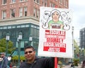 Teachers and supporters holding signs protesting at a Teacher Strike Rally in Oakland, CA