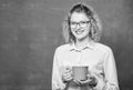 Teaching is greatest act of optimism. Woman enjoy coffee before school classes. Teacher in glasses drink coffee