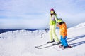 Teaching little boy to ski going holding hand Royalty Free Stock Photo