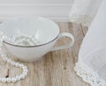 Teacup with Pearls on Wood Royalty Free Stock Photo