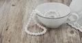 Teacup with Pearls on Wood Royalty Free Stock Photo