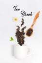 Teacup and scattered red tea leaves in steam shape. Mockup with tea and tea cup composition, copy space and empty space for text,