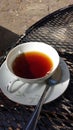 Teacup with spoon on porch table