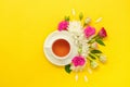 Teacup surrounded by flowers isolated on yellow Royalty Free Stock Photo