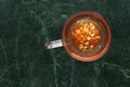 Teaglass with yellowhead root tea in a green marble background Royalty Free Stock Photo