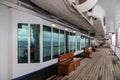 Teak bench and teak lined Promenade Deck of modern cruise ship Royalty Free Stock Photo