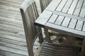 Teak garden furniture on a wooden terrace in spring