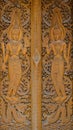 Teak Wood is Carved in Figure Shape of Guardian in Thai Traditional Style for Door Decoration Used. Royalty Free Stock Photo