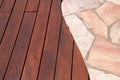 Teak wood deck and marble stone decorative tiled walkway detail, hardwood decking installed next natural marble stone slabs