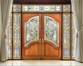 Teak wooden door with frosted glass interior.