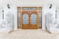 Teak wooden door with white lions statue. Royalty Free Stock Photo