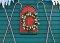 Teal blue wall with candy canes and holiday wreath