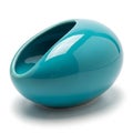 A teal ceramic vase with a spherical shape and an asymmetrical opening. The surface is glossy and Royalty Free Stock Photo