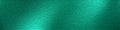 Teal foil background. Green colorful metallic foil texture. Turquoise shiny surface. Foil paper design for banner backdrop.