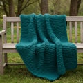 Teal Knitted Throw Blanket on Wooden Bench Royalty Free Stock Photo