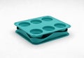 Turquoise silicone six-cup muffin pan stacked for compact storage isolated on white background Royalty Free Stock Photo