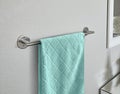 Teal Towel On Chrome Bathroom Rack on grey wall modern room