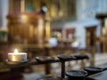Tealight candle burning in front of a church interior altar area Royalty Free Stock Photo