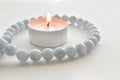 Tealight candles with aquamarine necklace. Royalty Free Stock Photo