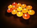 Tealight candles with blurred dark background. Royalty Free Stock Photo