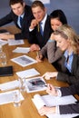 Team of 5 business people working on calculations Royalty Free Stock Photo