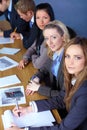 Team of 5 businesspeople working on paperwork