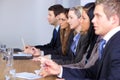 Team of 5 people sitting at conference table