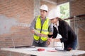 Team architect or engineer man and woman meeting for planning and strategy of development real estate at construction site. Royalty Free Stock Photo