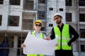 Team of architect or engineer wearing hardhat looking blueprint for inspection and planning construction.