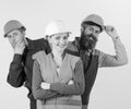 Team of architects, builders, labourers peeking behind leader isolated white background. Female leader concept. Woman Royalty Free Stock Photo