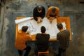 Team of Architects Collaboratively Designing Innovative Building Plans Using Blueprints, Developing Creative Architectural
