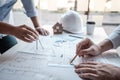 Team of architects or engineering consulting and analyzing working on objects tools and construction drawings inspection, Royalty Free Stock Photo