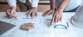 Team of architects or engineering consulting and analyzing working on objects tools and construction drawings inspection, Royalty Free Stock Photo